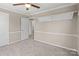 Cozy bedroom featuring neutral carpet, ceiling fan and convenient built in shelving at 27 Sw Barbee Rd, Concord, NC 28027