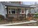 Charming single-story home featuring a covered front porch, gray siding, and well-maintained landscaping at 27 Sw Barbee Rd, Concord, NC 28027