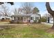 Charming single-story home with a welcoming front porch and a well-maintained yard with mature trees at 27 Sw Barbee Rd, Concord, NC 28027