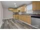Bright kitchen featuring wood cabinets, neutral countertops, and durable laminate flooring at 27 Sw Barbee Rd, Concord, NC 28027