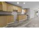 Functional kitchen with ample wood cabinetry, gray counter tops, and laminate flooring at 27 Sw Barbee Rd, Concord, NC 28027