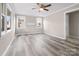 Bright living room with laminate flooring, fresh paint, and multiple windows at 27 Sw Barbee Rd, Concord, NC 28027