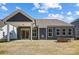 An inviting backyard featuring a fire pit and covered patio at 4021 Grace Pointe Dr # 104, Wesley Chapel, NC 28079
