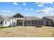 Backyard view showcasing a fire pit and covered patio at 4021 Grace Pointe Dr # 104, Wesley Chapel, NC 28079