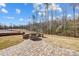 Stunning backyard featuring a stone fire pit and manicured lawn, perfect for outdoor entertaining at 4021 Grace Pointe Dr # 104, Wesley Chapel, NC 28079