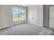 This bedroom features a window with a view and a double-door closet at 4021 Grace Pointe Dr # 104, Wesley Chapel, NC 28079