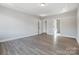 Open bedroom with a tray ceiling and doorway to bathroom at 4021 Grace Pointe Dr # 104, Wesley Chapel, NC 28079