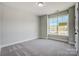 This bedroom features a large window offering plenty of natural light at 4021 Grace Pointe Dr # 104, Wesley Chapel, NC 28079