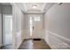 Inviting entryway with hardwood floors, detailed trim, and a view of the front door at 4021 Grace Pointe Dr # 104, Wesley Chapel, NC 28079