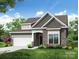 Charming home featuring a stone facade, attached two car garage, and beautifully landscaped front yard at 4021 Grace Pointe Dr # 104, Wesley Chapel, NC 28079