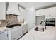 A well-equipped kitchen featuring sleek countertops, backsplash, modern appliances, and ample cabinet space at 4021 Grace Pointe Dr # 104, Wesley Chapel, NC 28079