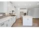 Well-lit kitchen with white cabinets, quartz countertops, a stylish backsplash, and modern appliances at 4021 Grace Pointe Dr # 104, Wesley Chapel, NC 28079