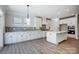 Elegant kitchen boasts white cabinets, an island with a sink, and stainless steel appliances at 4021 Grace Pointe Dr # 104, Wesley Chapel, NC 28079