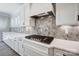 Bright kitchen with a modern gas cooktop, white countertops, and stylish tile backsplash at 4021 Grace Pointe Dr # 104, Wesley Chapel, NC 28079