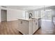 Open concept kitchen with a large island, stainless steel appliances, and hardwood floors throughout at 4021 Grace Pointe Dr # 104, Wesley Chapel, NC 28079