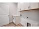 Well-lit laundry room with ample cabinet space and sleek countertops at 4021 Grace Pointe Dr # 104, Wesley Chapel, NC 28079