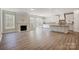 Open-concept living area with a fireplace, sliding glass doors, and seamless flow to the kitchen at 4021 Grace Pointe Dr # 104, Wesley Chapel, NC 28079