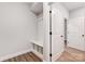 Bright mudroom with a built-in bench, storage cubbies, and coat hooks at 4021 Grace Pointe Dr # 104, Wesley Chapel, NC 28079