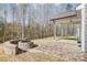 Picturesque backyard patio area with a custom stone firepit and covered porch for relaxation and enjoyment at 4021 Grace Pointe Dr # 104, Wesley Chapel, NC 28079