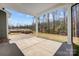 Large covered patio with pavers and view of wooded area at 4021 Grace Pointe Dr # 104, Wesley Chapel, NC 28079