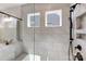 Detailed view of a glass shower with a rain shower head and built-in niche at 4021 Grace Pointe Dr # 104, Wesley Chapel, NC 28079