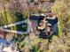 Expansive aerial view of the house and surrounding landscape, featuring a long driveway and lush trees at 6040 Oxfordshire Rd, Waxhaw, NC 28173