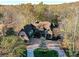 Expansive aerial view of a luxurious home nestled among trees, highlighting its large lot at 6040 Oxfordshire Rd, Waxhaw, NC 28173
