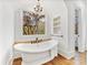 Charming bathroom with a clawfoot tub below a window and detailed chandelier at 6040 Oxfordshire Rd, Waxhaw, NC 28173