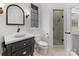 Bathroom with a pedestal sink, toilet, glass-enclosed shower, and tile floors at 6040 Oxfordshire Rd, Waxhaw, NC 28173