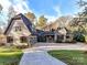 Stunning stone and brick home with a circular driveway and manicured lawn at 6040 Oxfordshire Rd, Waxhaw, NC 28173