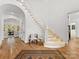 Elegant foyer features a curved staircase, hardwood floors, and a bright, open space at 6040 Oxfordshire Rd, Waxhaw, NC 28173
