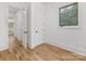 Hallway with white trim, paneled doors and wood floors at 6040 Oxfordshire Rd, Waxhaw, NC 28173
