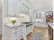 Bright kitchen featuring stainless appliances, white cabinets, and sleek countertops at 6040 Oxfordshire Rd, Waxhaw, NC 28173