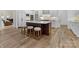 Spacious kitchen featuring an island with seating, stainless steel appliances, and custom cabinets at 6040 Oxfordshire Rd, Waxhaw, NC 28173