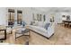 Bright living room with a neutral color palette, hardwood floors, and access to the porch at 6040 Oxfordshire Rd, Waxhaw, NC 28173