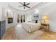 Bright main bedroom features a fireplace, balcony access, a ceiling fan, and an ensuite at 6040 Oxfordshire Rd, Waxhaw, NC 28173