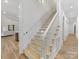 Wooden stairway with white spindles and handrail at 6040 Oxfordshire Rd, Waxhaw, NC 28173