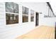 Townhouse with a wooden deck with access to the unit, as well as a view into a kitchen at 7928 Cedarsmith Ct, Charlotte, NC 28217
