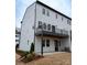 Exterior of a modern three-story townhouse with a deck and a walk out patio at 7928 Cedarsmith Ct, Charlotte, NC 28217