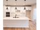 Bright kitchen with quartz counters, stainless appliances, and black pendant lighting at 7928 Cedarsmith Ct, Charlotte, NC 28217