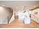 Open concept living room with hardwood floors, staircase, and modern kitchen at 7928 Cedarsmith Ct, Charlotte, NC 28217