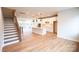 Spacious living room featuring hardwood floors, staircase, and a modern kitchen at 7928 Cedarsmith Ct, Charlotte, NC 28217