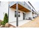 View of a walk-out patio area on a modern, three-story townhouse with black trim at 7928 Cedarsmith Ct, Charlotte, NC 28217