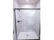 Walk-in shower featuring sleek black trim, a modern showerhead and tiled walls at 7928 Cedarsmith Ct, Charlotte, NC 28217