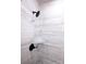 Close-up of a shower with black fixtures and light marble-look tile, and a built-in shower niche at 7928 Cedarsmith Ct, Charlotte, NC 28217