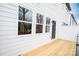 A bright outdoor back deck adjoins a house with white vinyl siding at 7940 Cedarsmith Ct, Charlotte, NC 28217