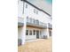 Multi-level back exterior showcasing balcony with railings, white siding, and sliding glass doors at 7940 Cedarsmith Ct, Charlotte, NC 28217