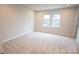 Bright bedroom with natural light, neutral paint, and wall to wall carpeting at 7940 Cedarsmith Ct, Charlotte, NC 28217