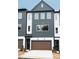 Beautiful exterior elevation of a modern townhome featuring a two-car garage and stylish gray and white siding at 7940 Cedarsmith Ct, Charlotte, NC 28217