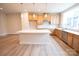 Bright, modern kitchen features an island, stainless appliances, and beautiful wood flooring at 7940 Cedarsmith Ct, Charlotte, NC 28217